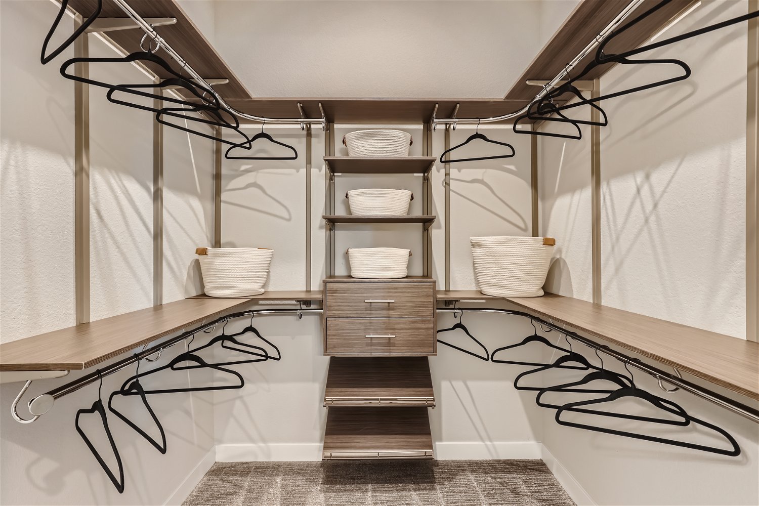 A room with a shelf and a table with a basket and a basket.