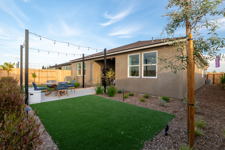 A backyard with a table and chairs.
