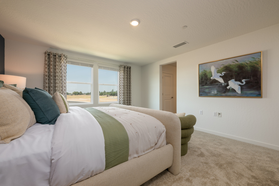 A bedroom with a bed and a couch.