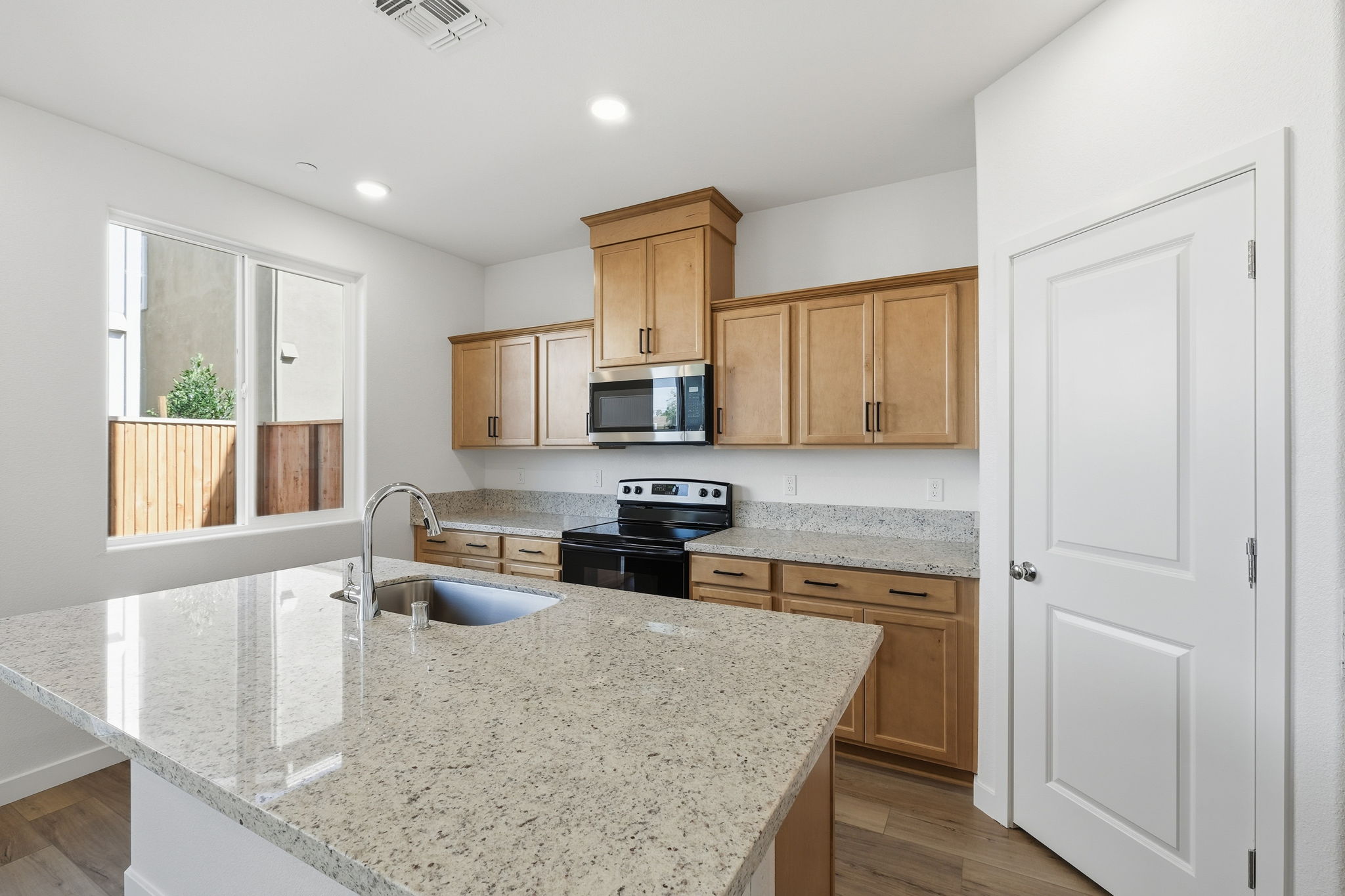 A kitchen with marble counters.