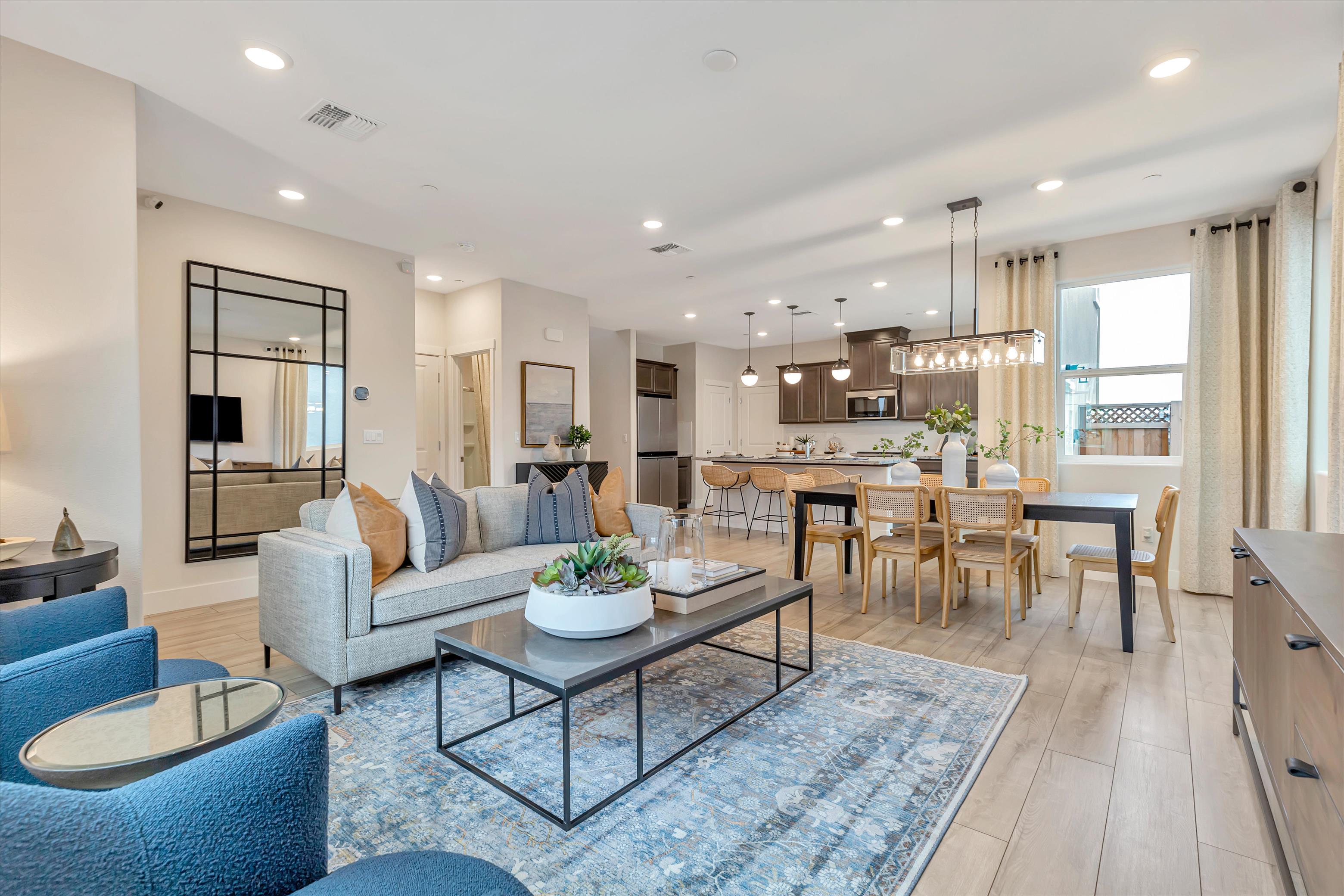 A large living room with a large dining table and a large kitchen.