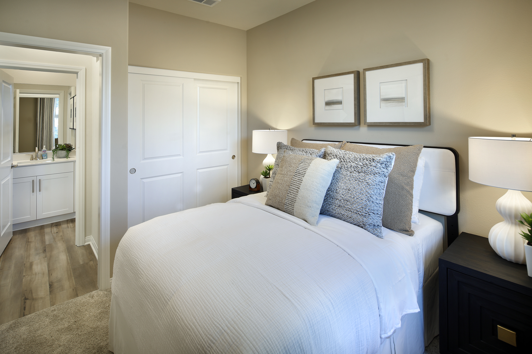 A bed with a white bed spread.