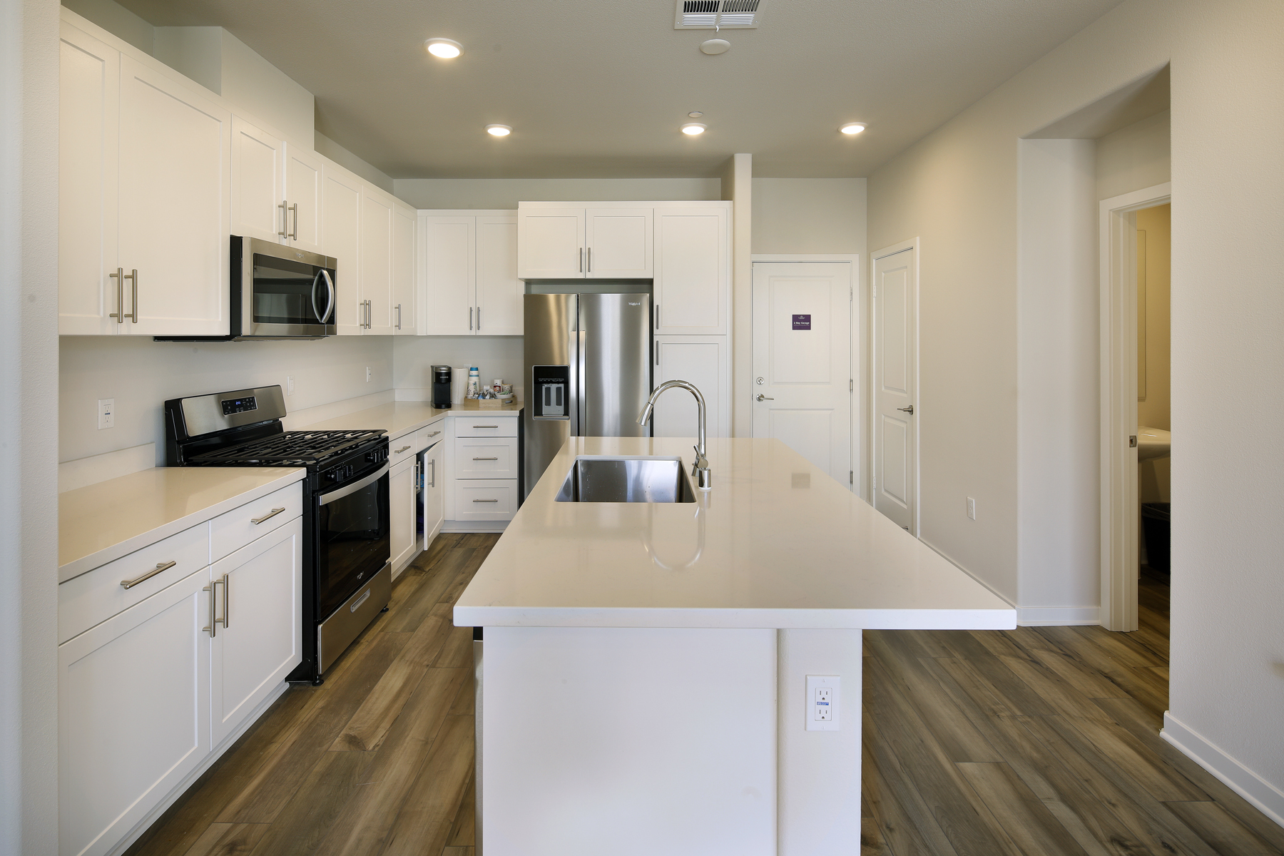 A kitchen with white cabinets.