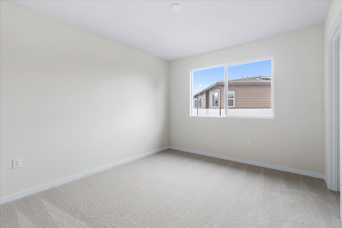 A room with a window and a carpet.