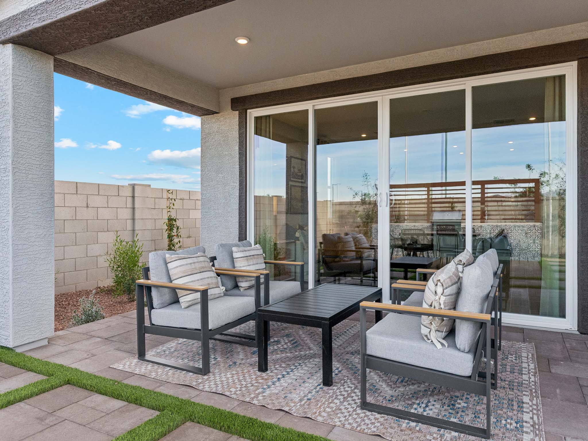A patio with a table and chairs.