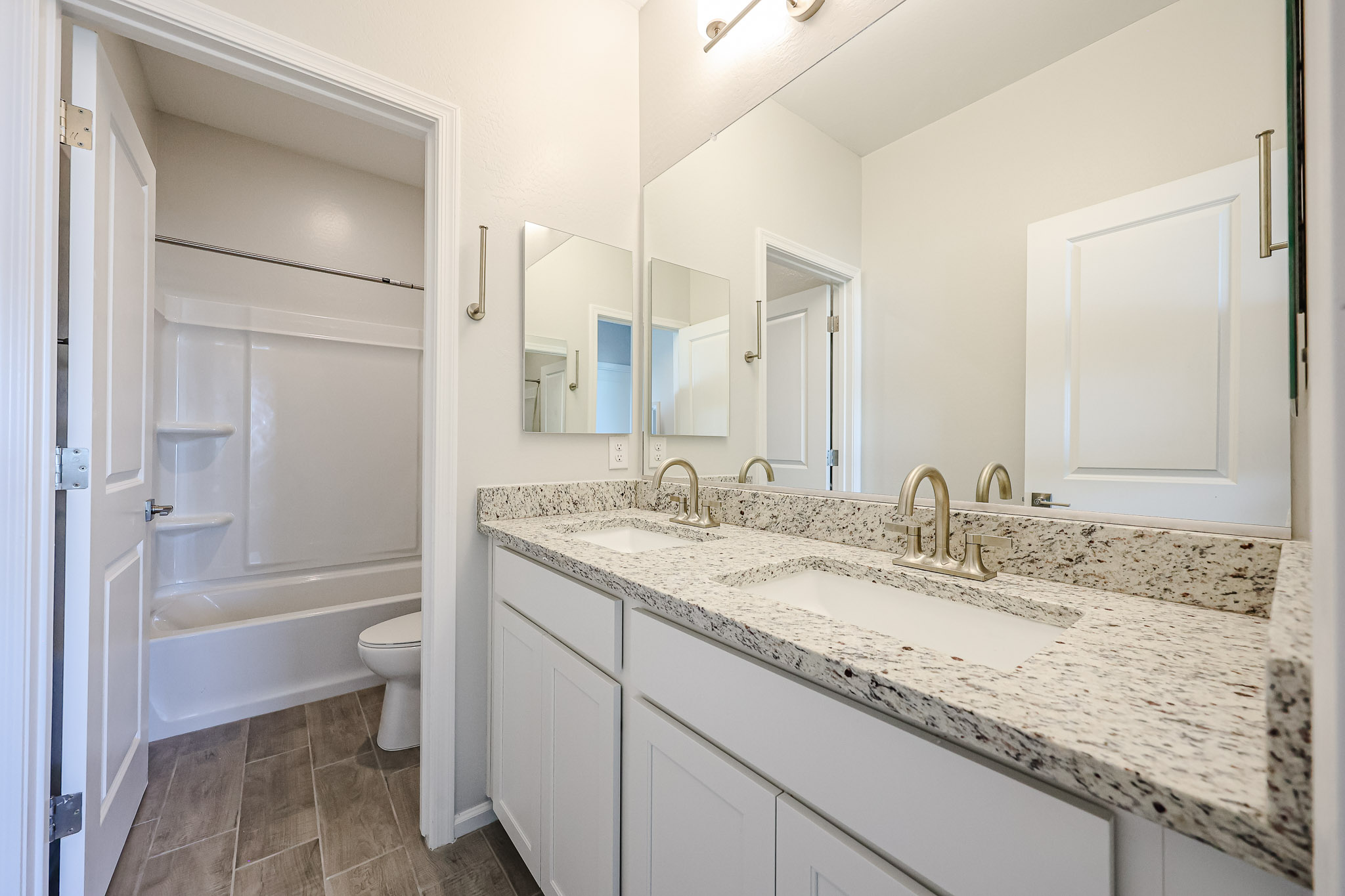 A bathroom with a tub sink and toilet.
