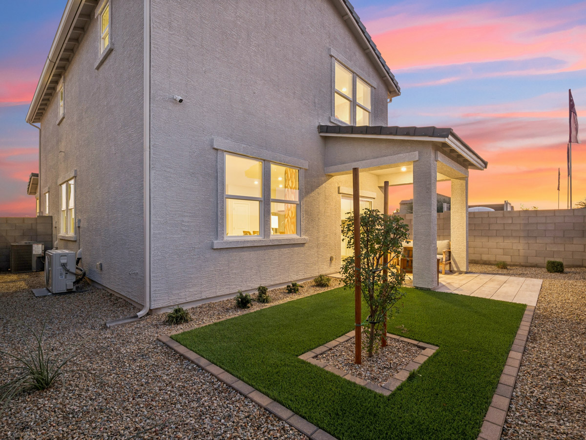 A house with a small tree in the front yard.