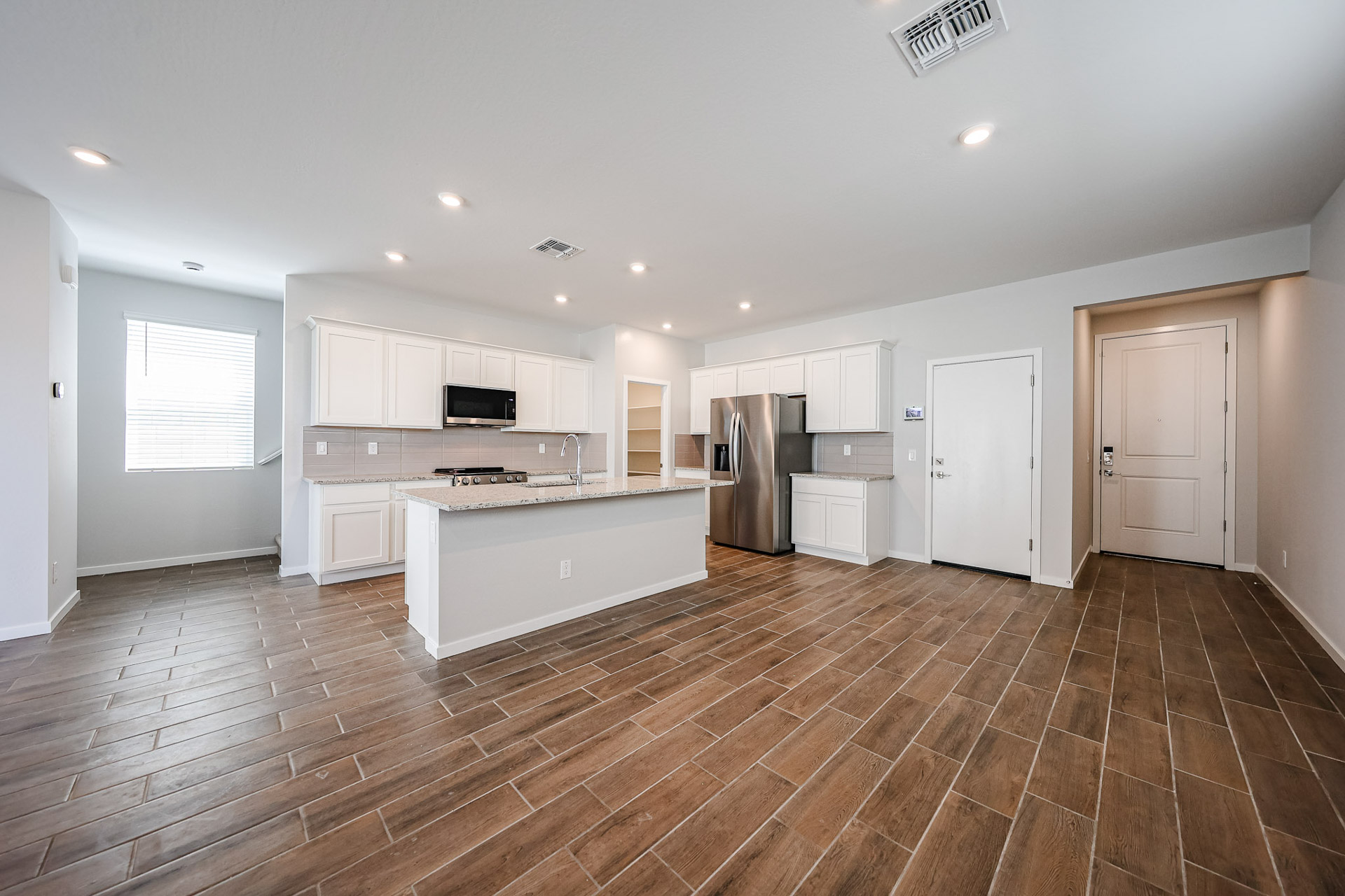 A large kitchen with white cabinets.