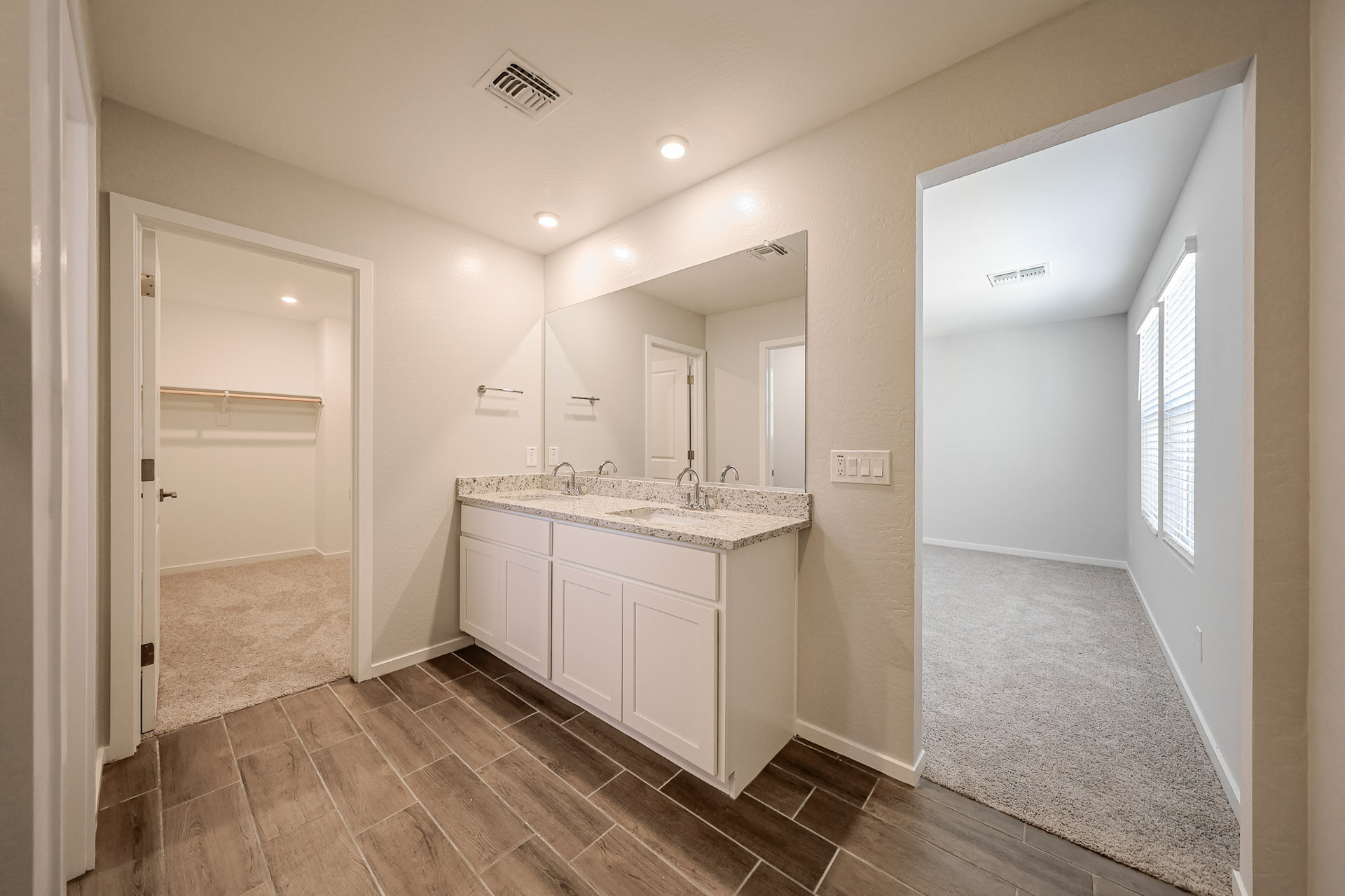 A bathroom with a large mirror.