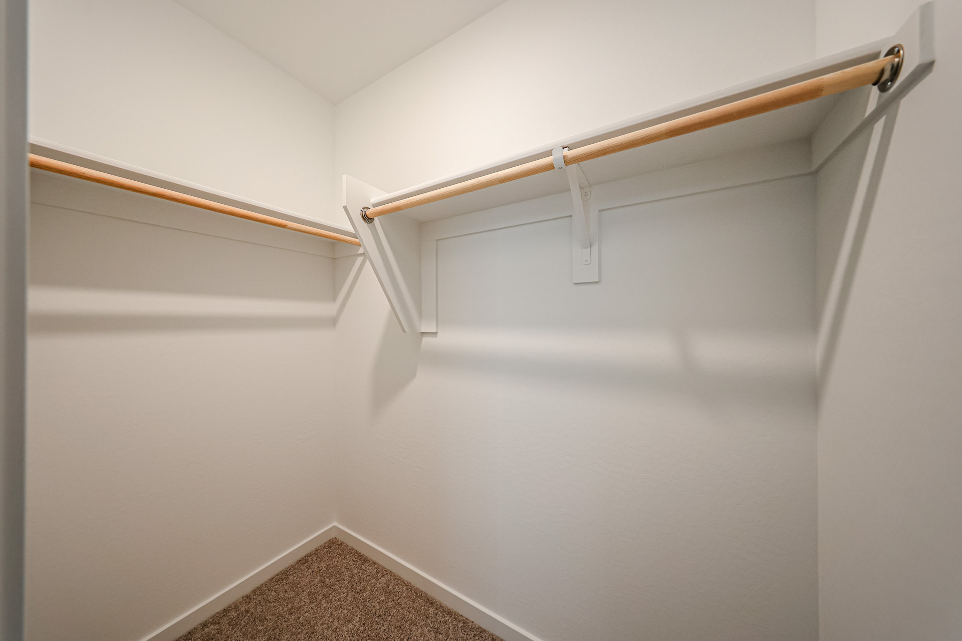 A white wall with a metal bar.