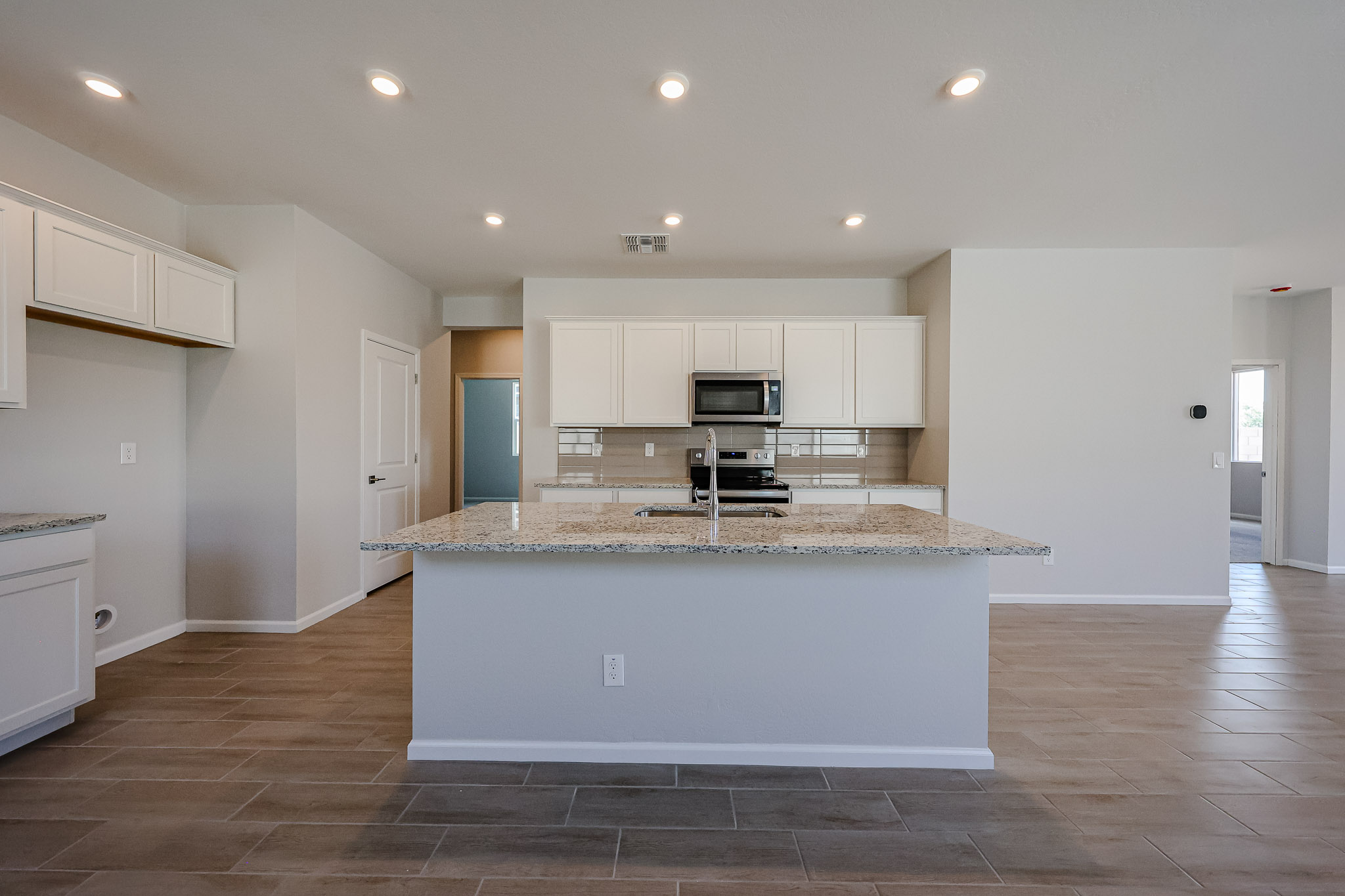 A kitchen with white cabinets.