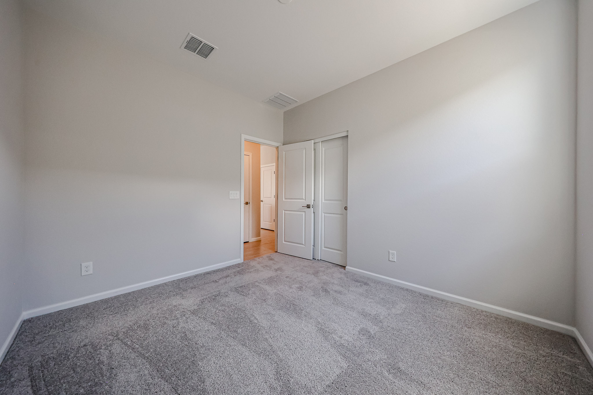 A hallway with white doors.