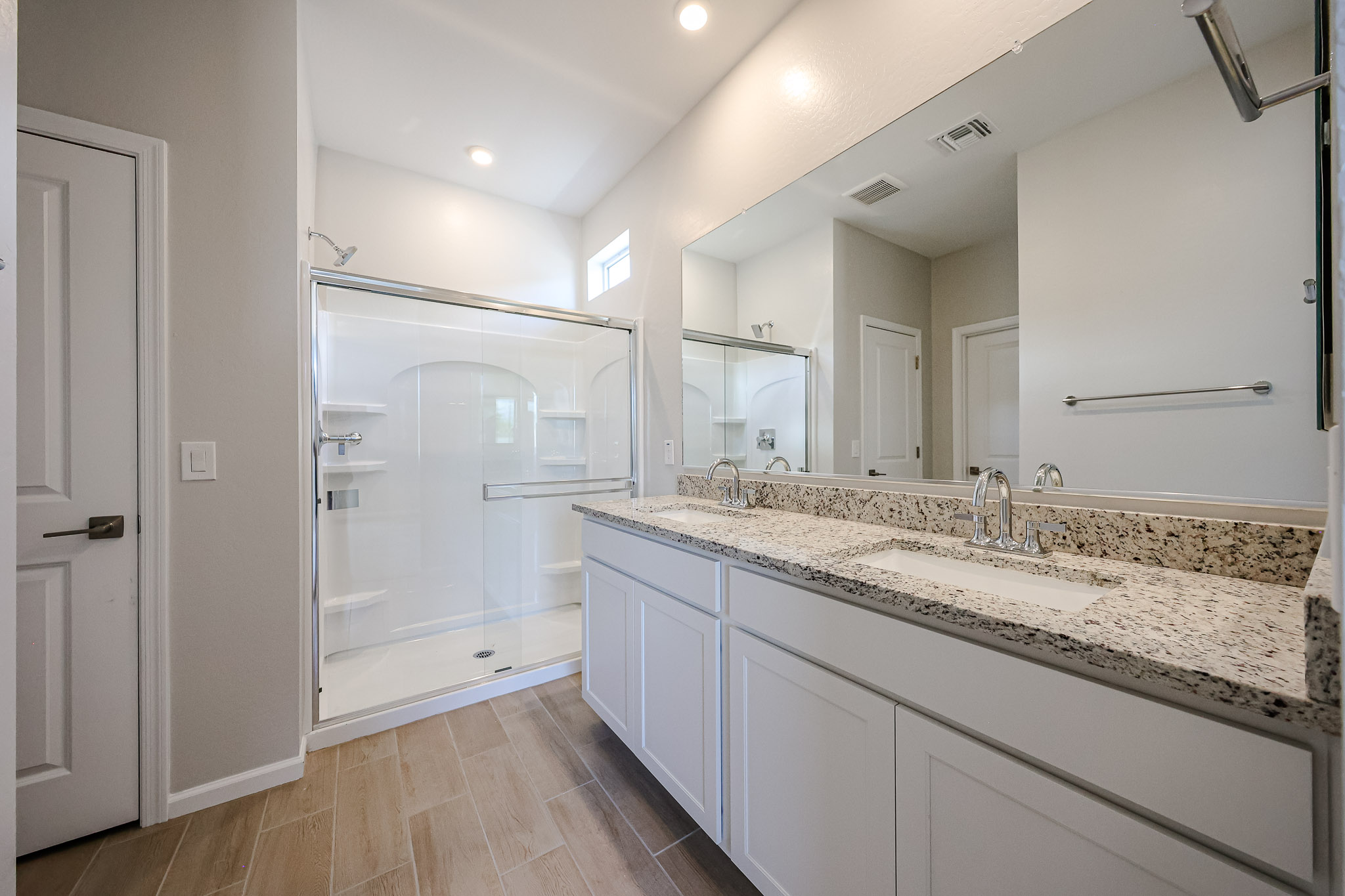 A bathroom with a large mirror.