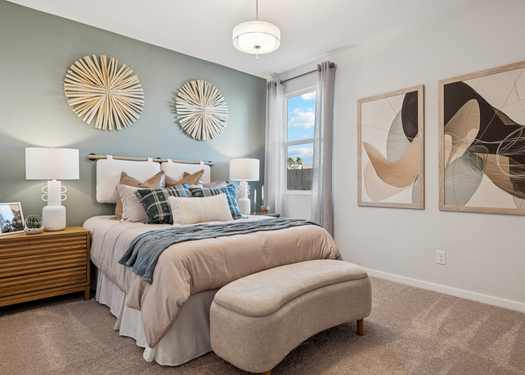 A bedroom with a bed and lamps.