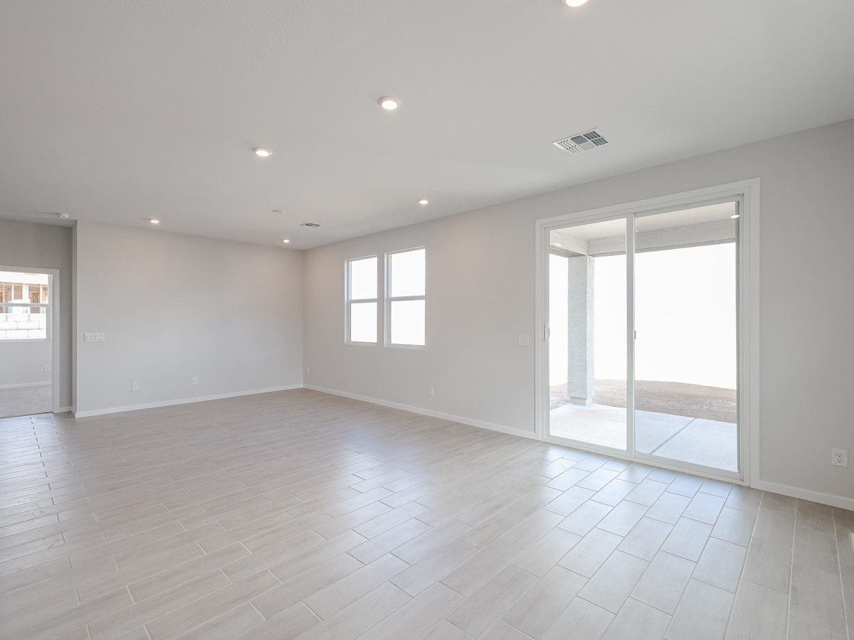 A room with a glass door and a wood floor.