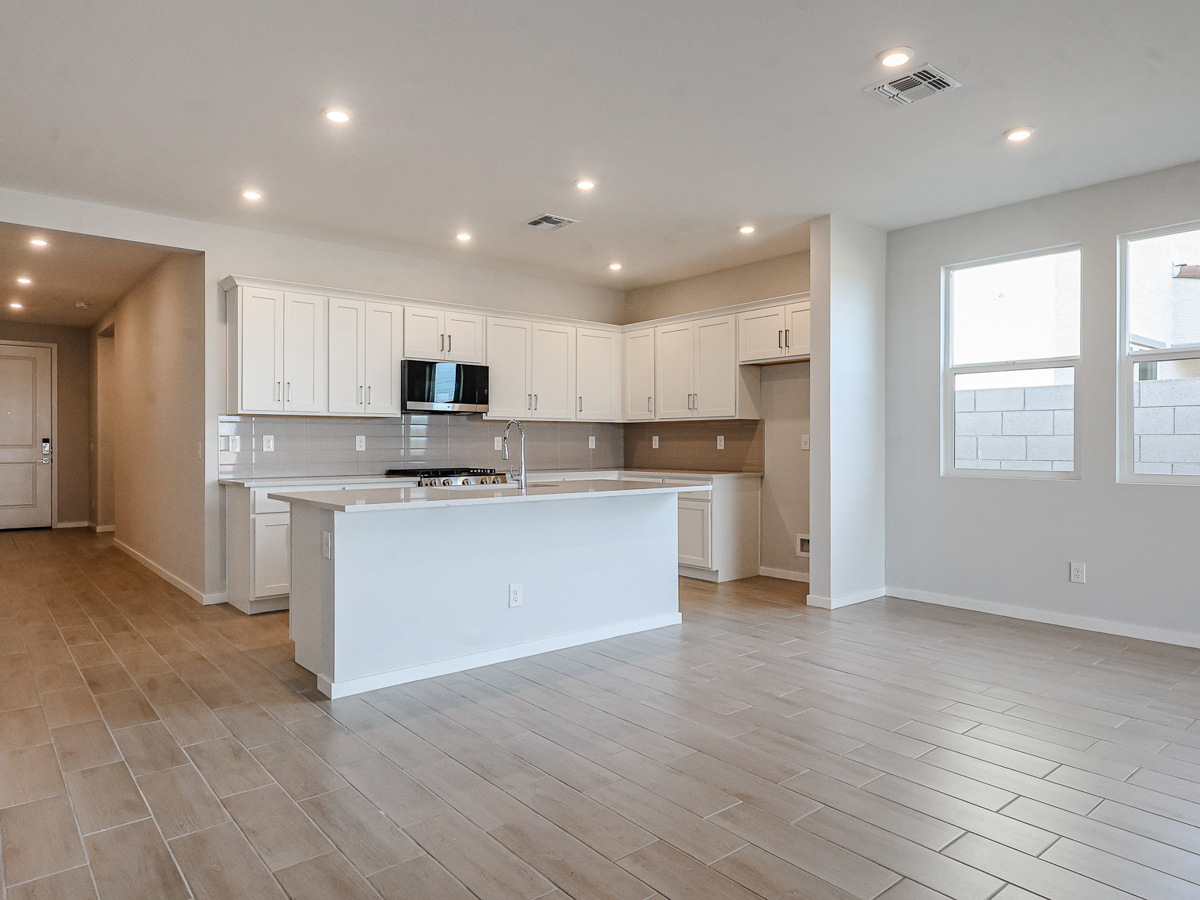 A kitchen with white cabinets.