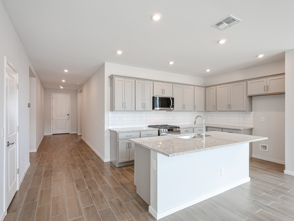 A kitchen with white cabinets.