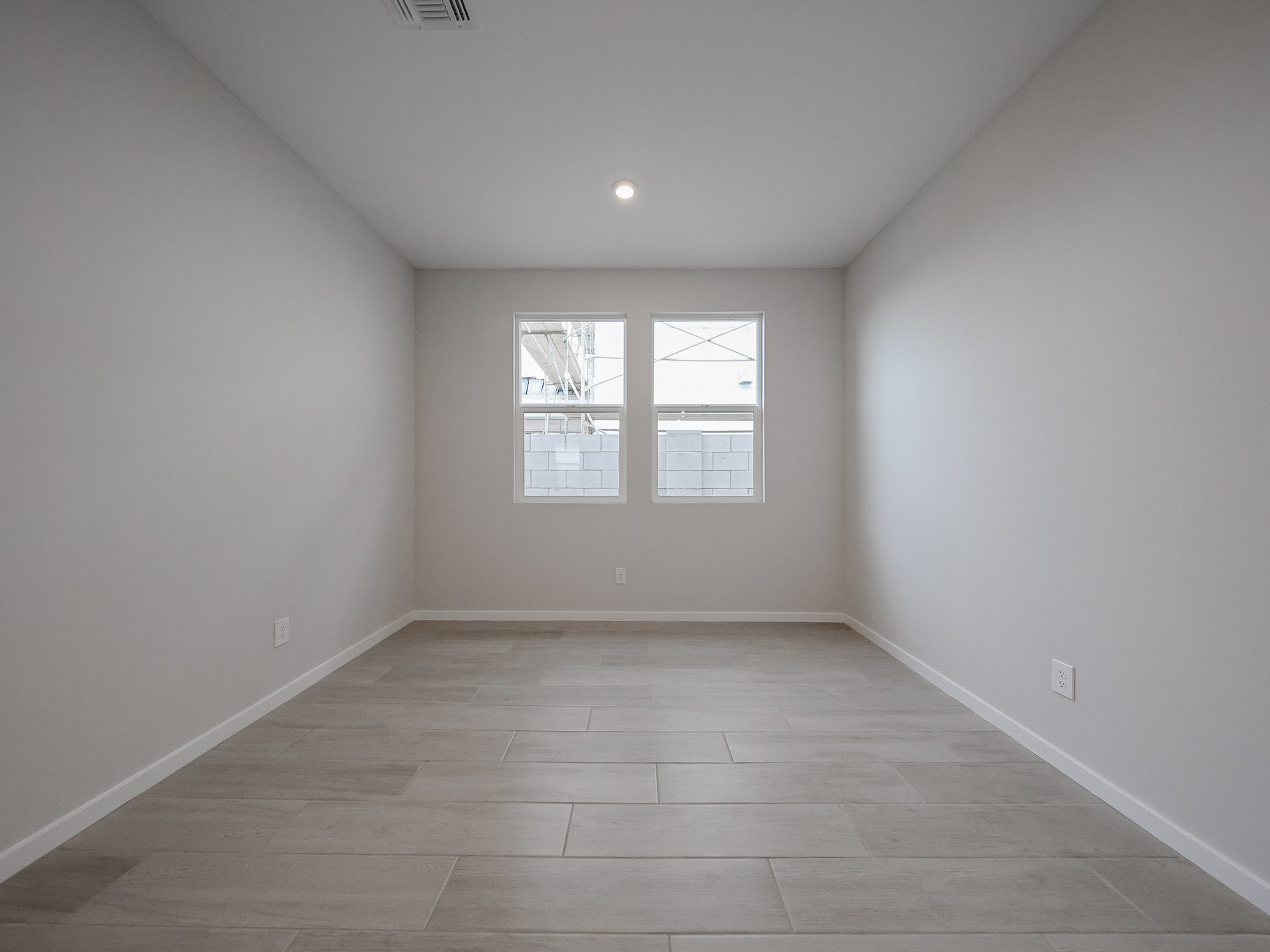 A room with a wood floor and a window.
