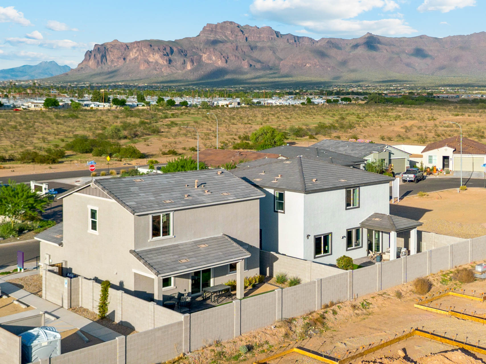 A group of houses in front of a mountain.
