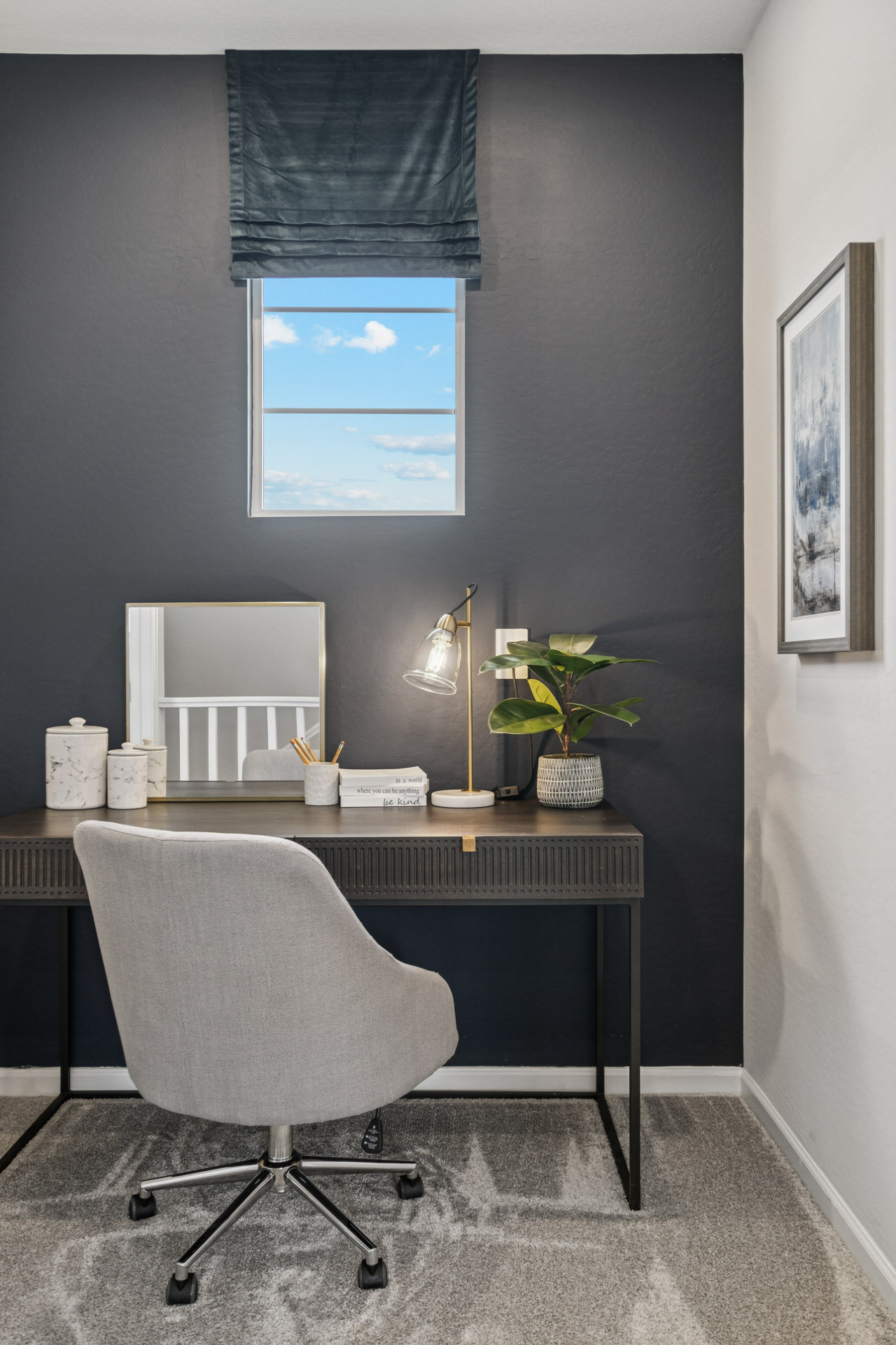 A desk with a chair and a window.