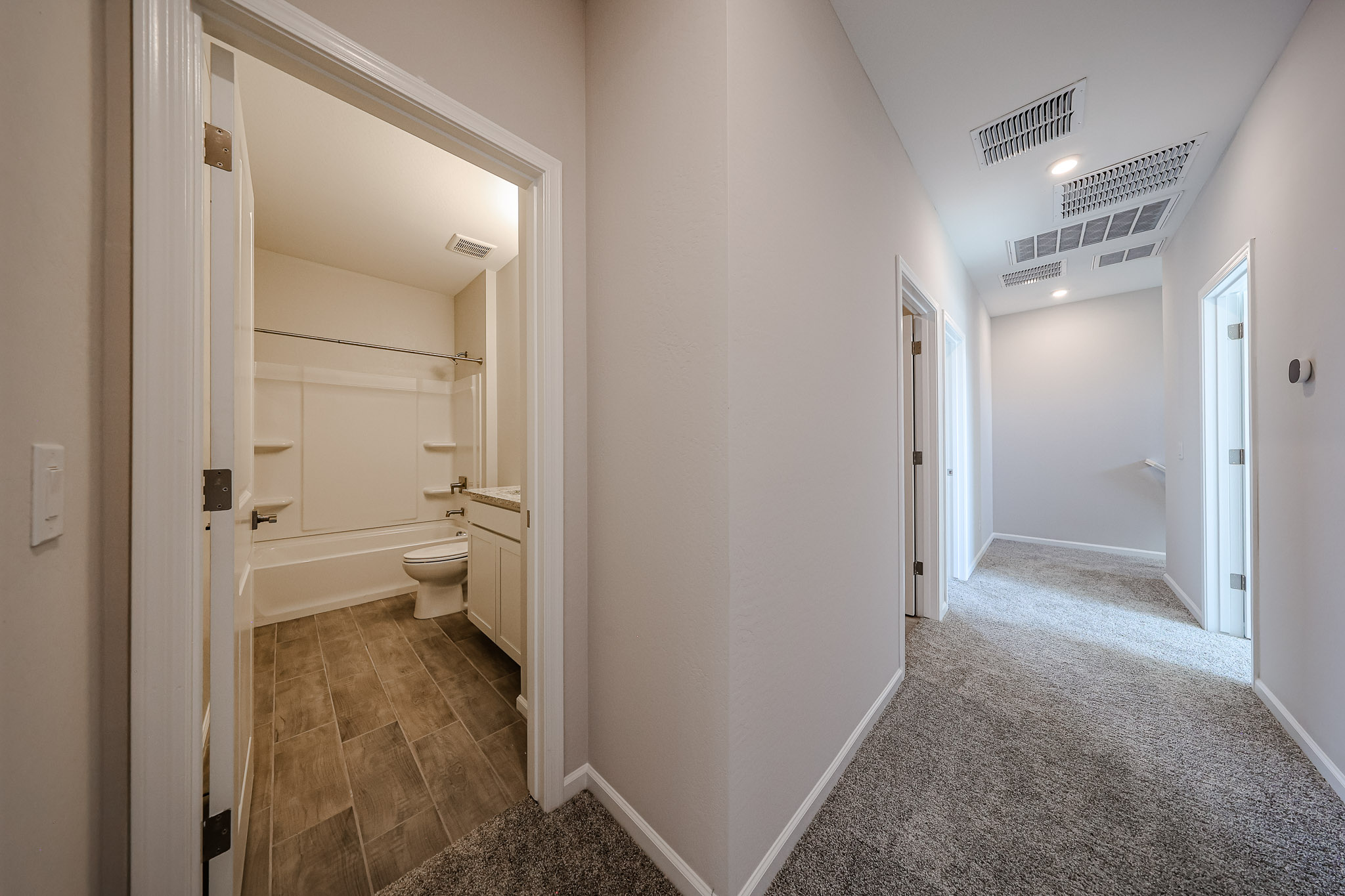 A bathroom with a tub and toilet.
