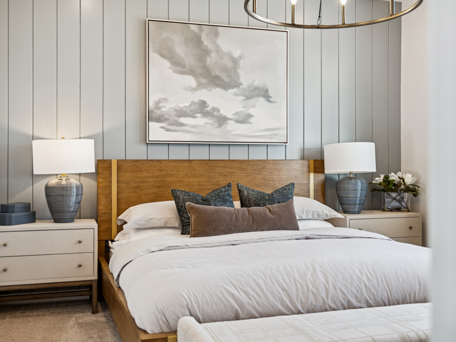 A bedroom with a large picture on the wall.