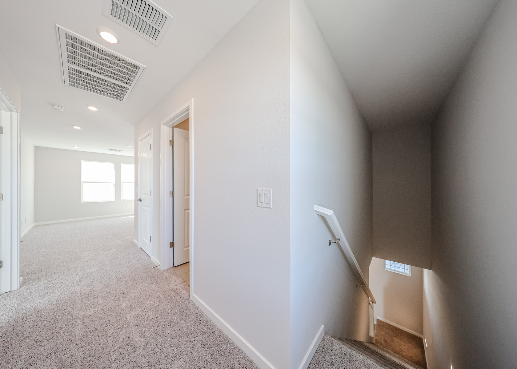 A hallway with white walls.