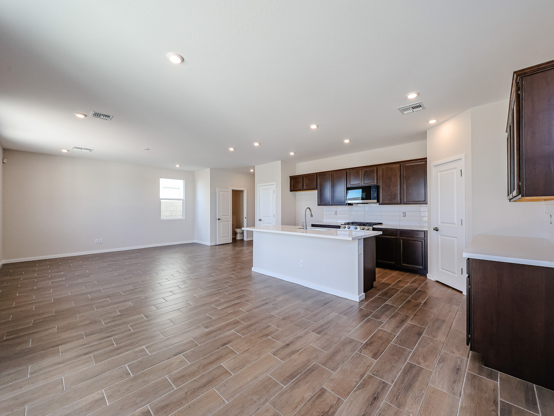 A large kitchen with wooden floors.
