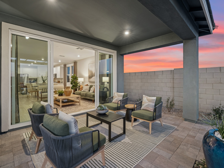A living room with a patio and a large glass door.