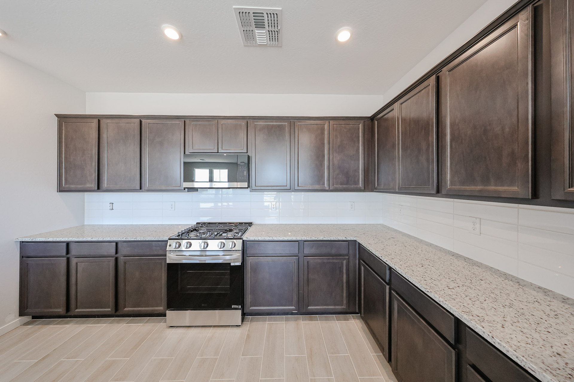 A kitchen with black cabinets.
