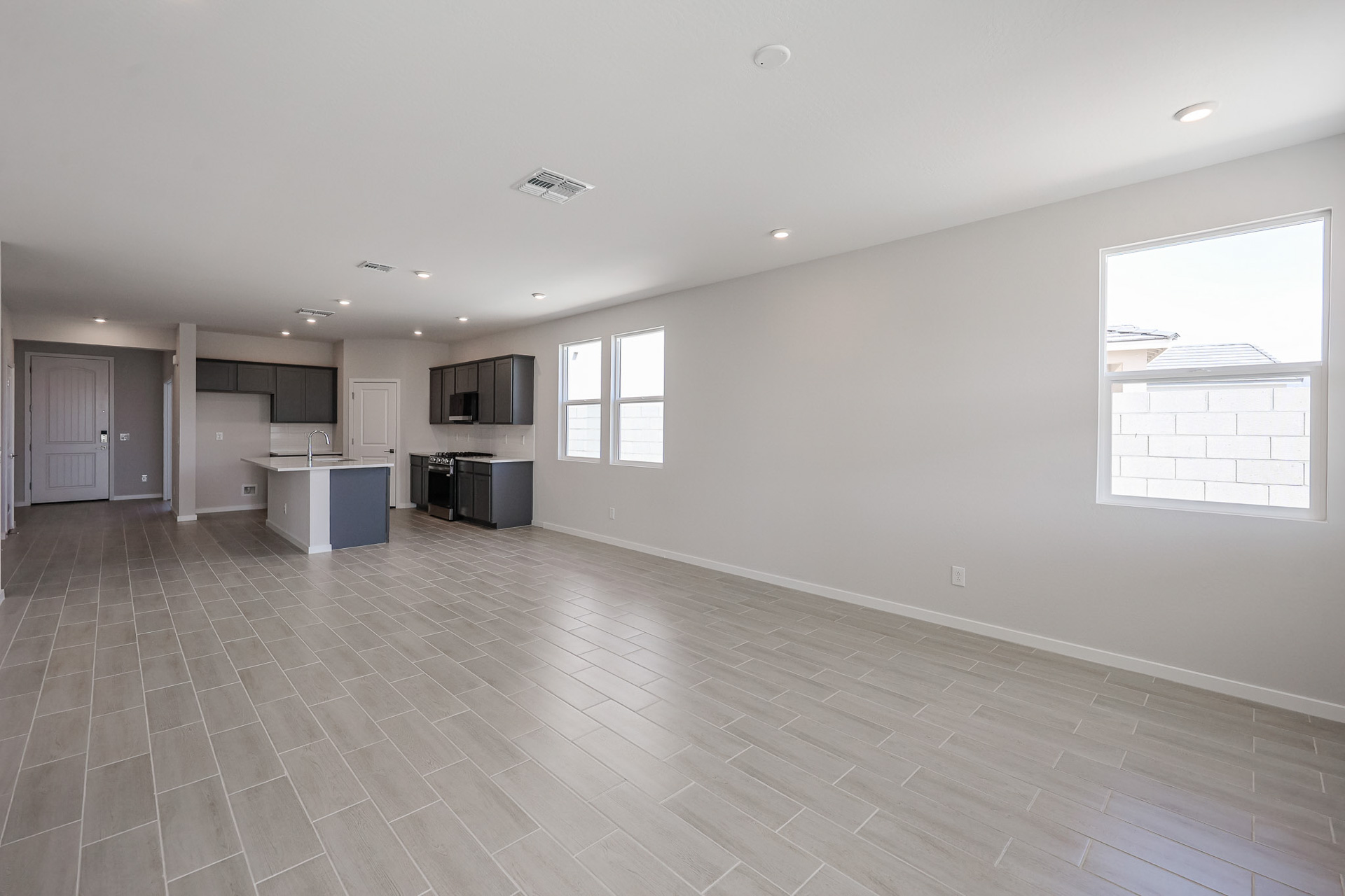 A large empty room with a wood floor and white walls.