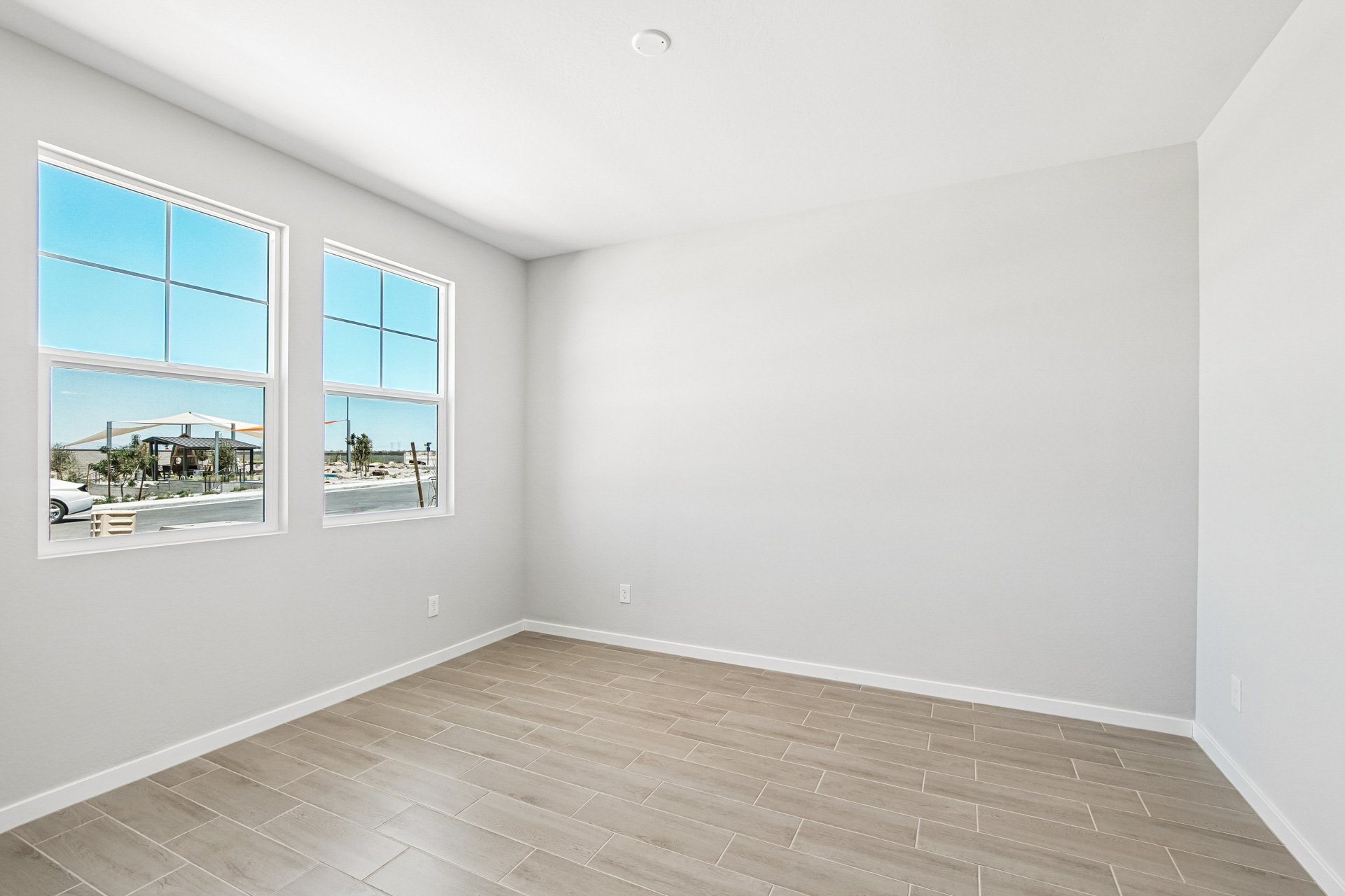 A room with a tile floor and windows.