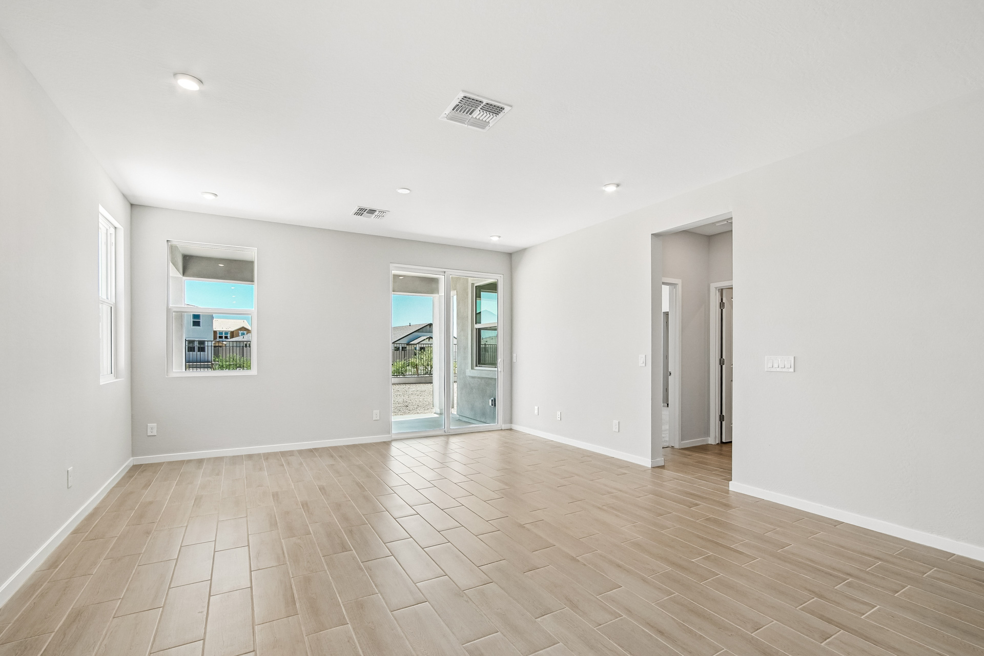 A room with white walls and a wood floor.