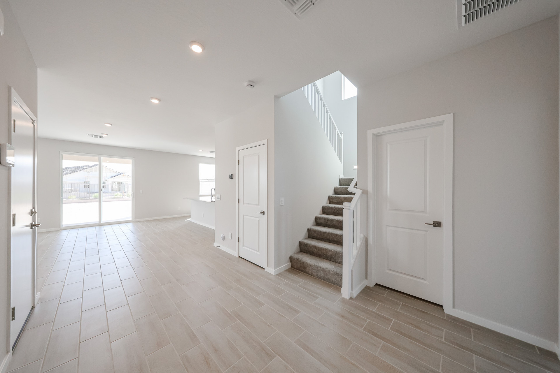 A large empty room with white doors.