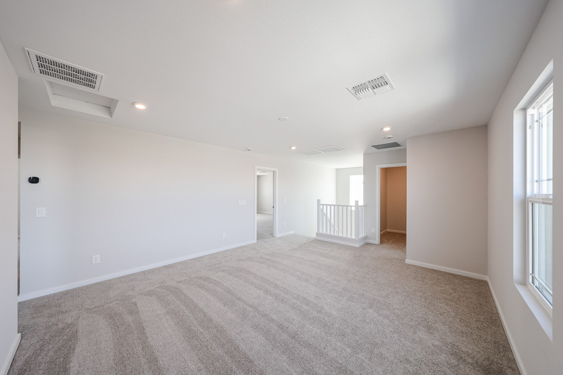 A long hallway with a carpet.
