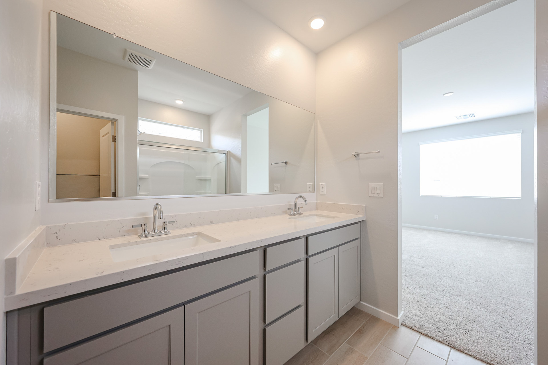A bathroom with a large mirror.