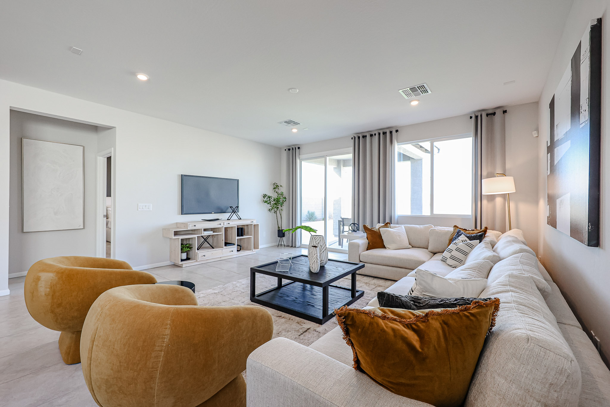 A living room with a large tv and couches.