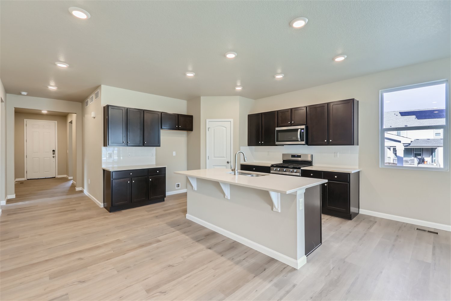 A kitchen with black cabinets.
