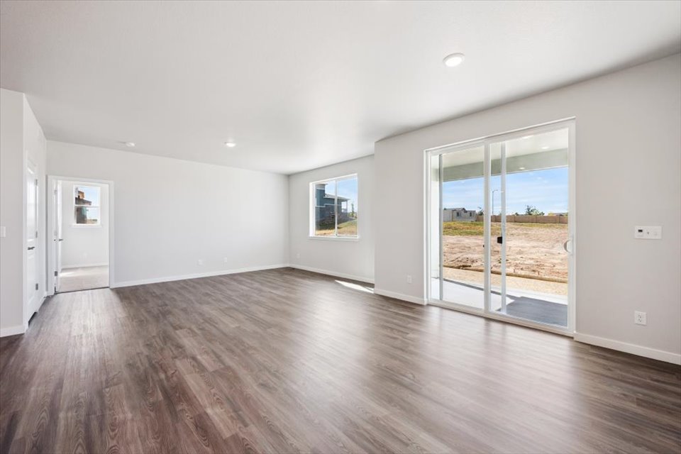 A room with a wood floor and a glass door.