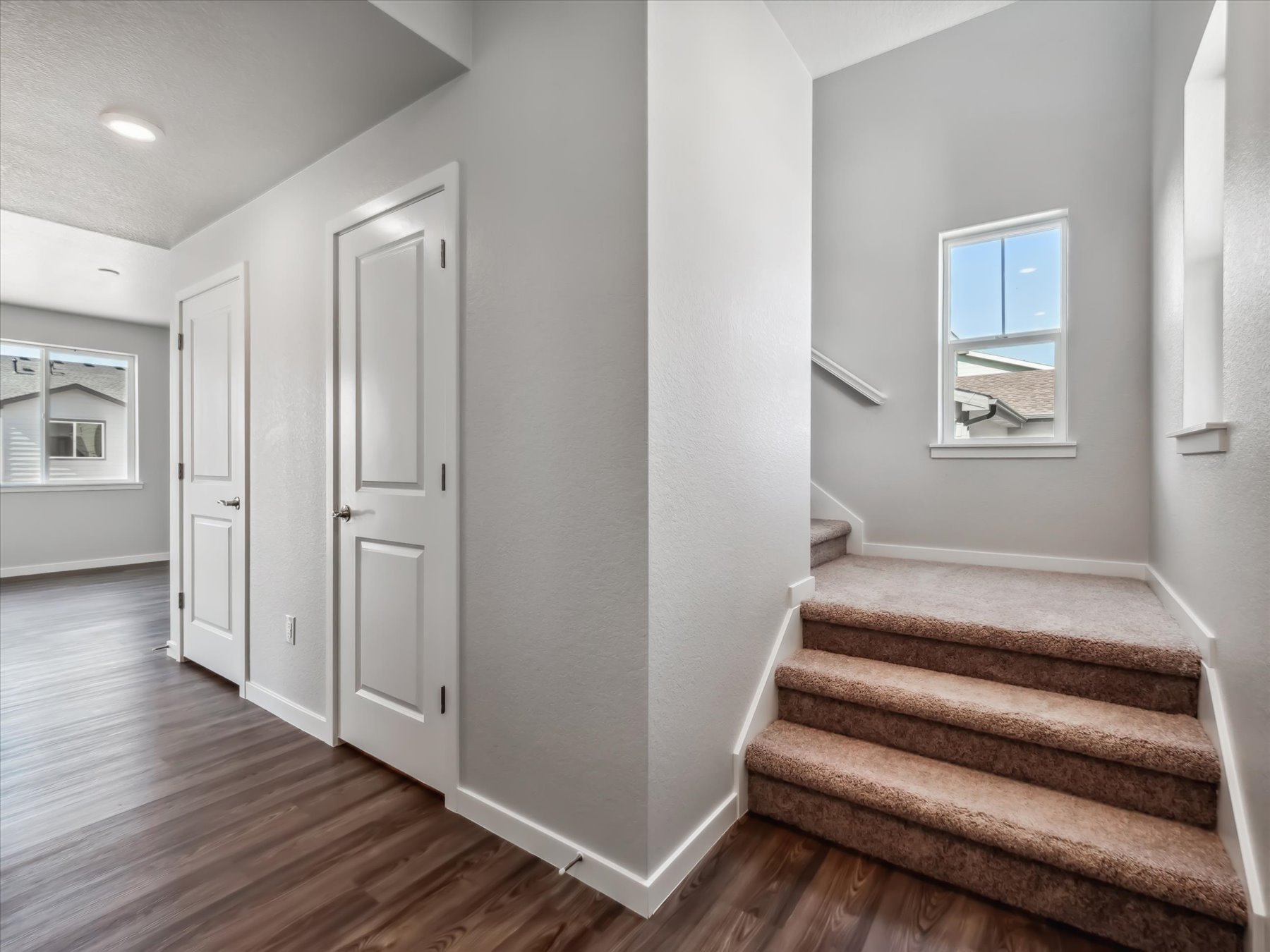 A room with white walls and a wood floor.