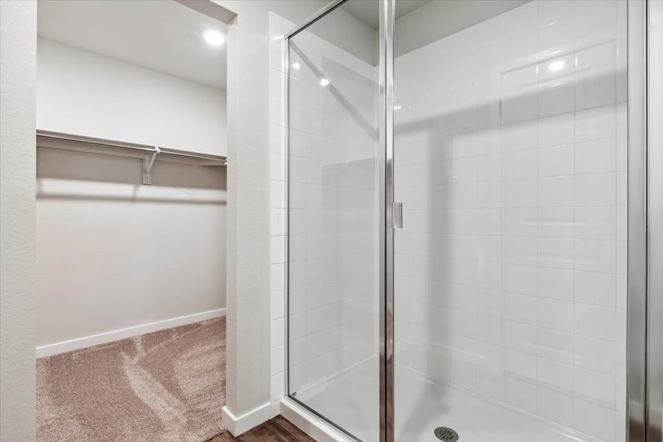 A shower with a glass door.