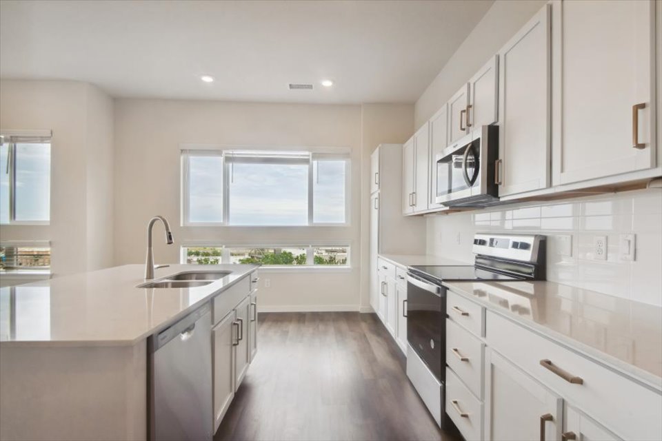 A kitchen with white cabinets.