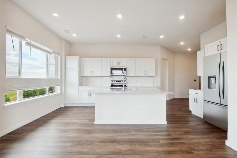 A kitchen with white cabinets.