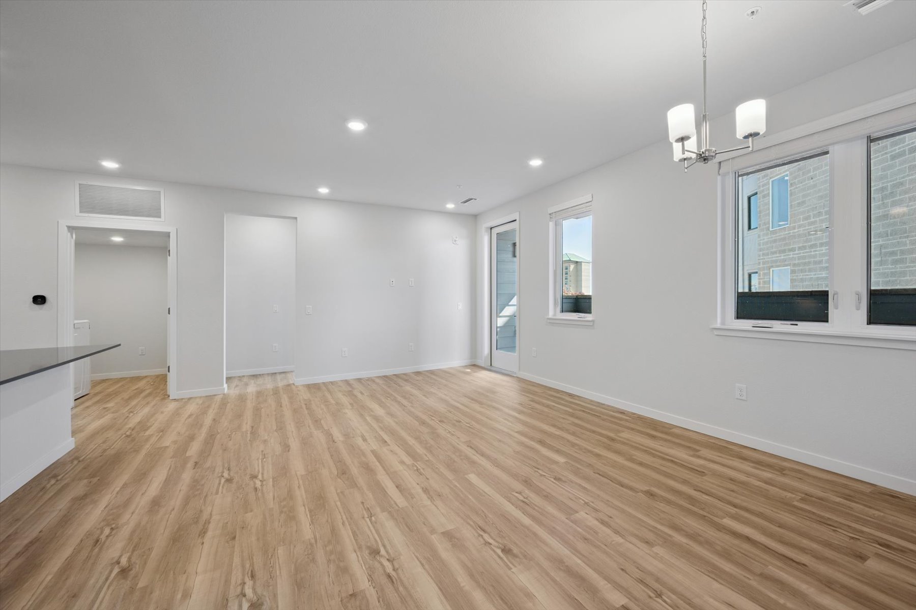 A room with a wood floor and white walls.