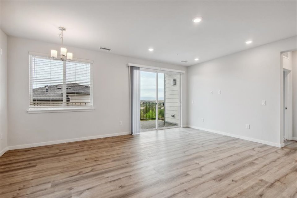 A room with a wood floor and a wood floor with a window.