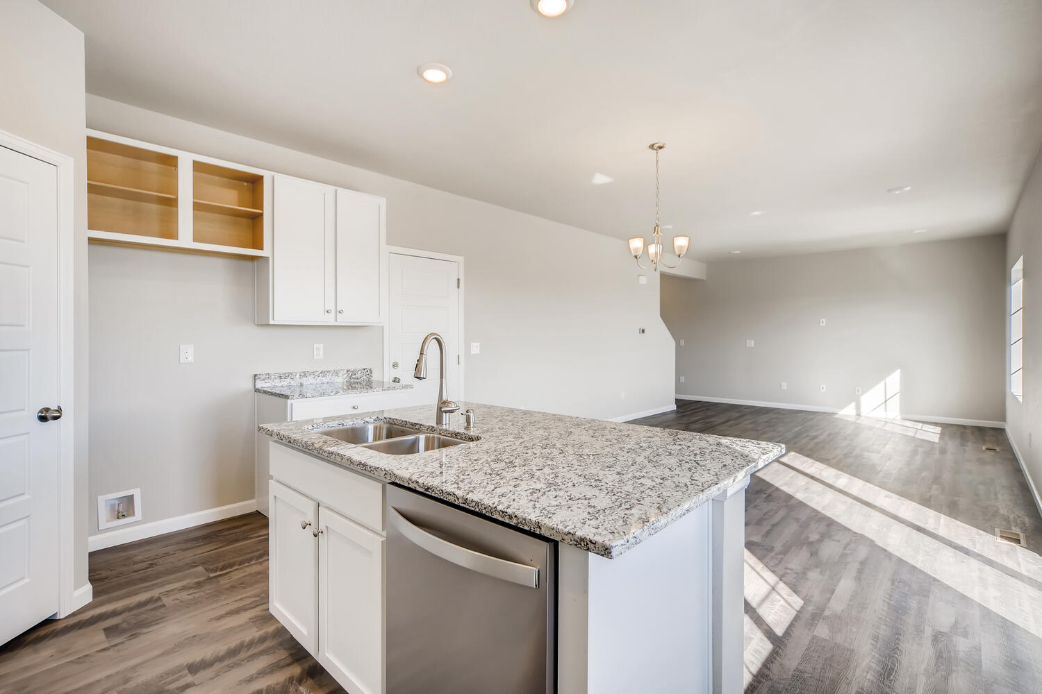 A kitchen with marble counters.