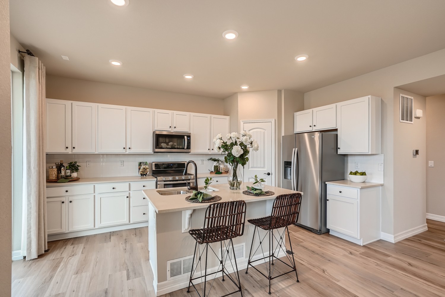A kitchen with white cabinets.