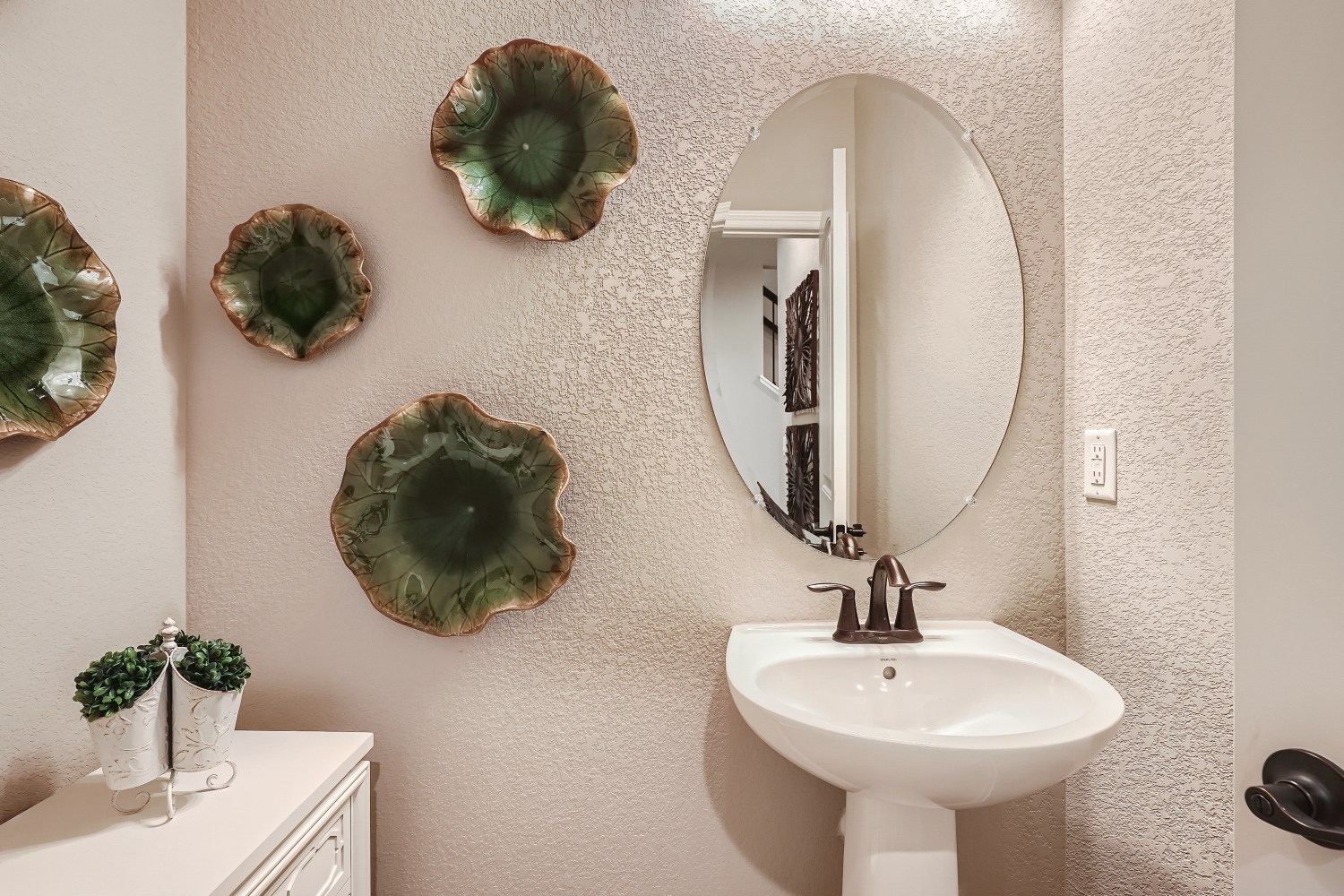 A bathroom with a mirror and a sink.