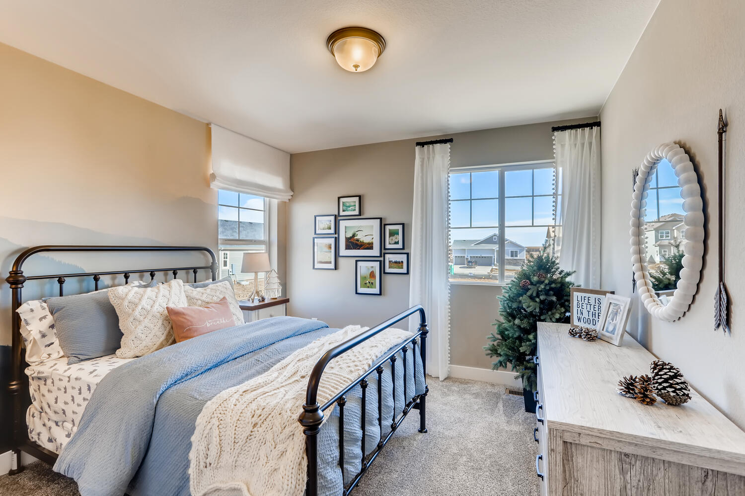 A bedroom with a bed and a mirror.