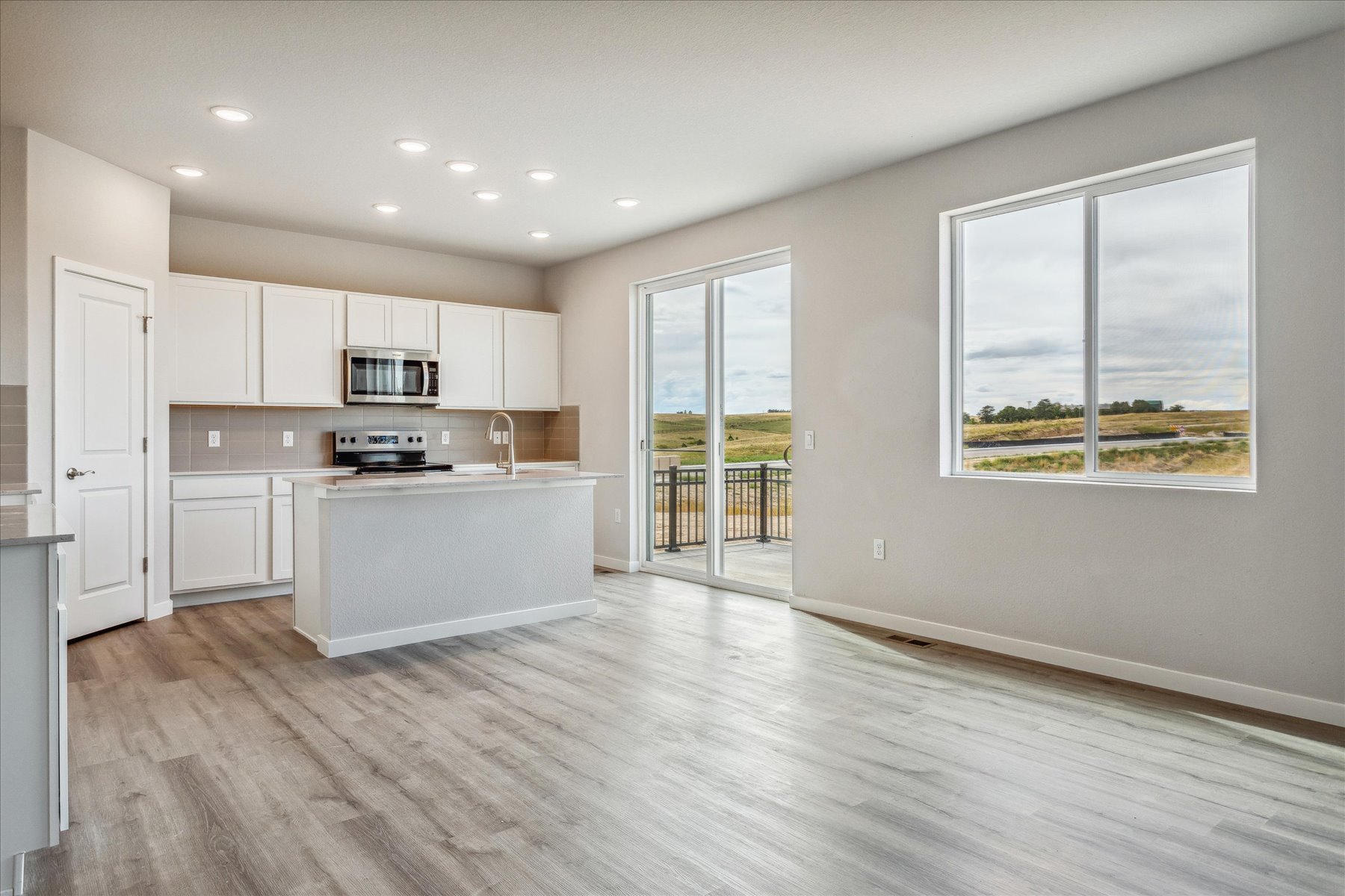 A kitchen with white cabinets.